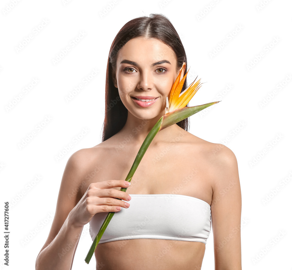 Beautiful young woman with flower on white background
