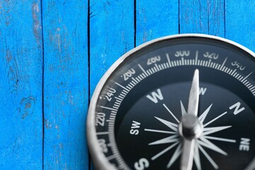 brass antique classical compass on wooden desk