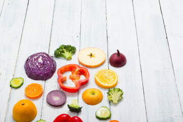 Canvas Print - sliced fruit and vegetable circles on white wood table