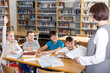 © JackF - Young female teacher and pupils working in classroom at elementary school..