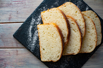 Wall Mural - sliced bread on iron plate on wooden table