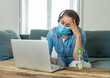© SB Arts Media - Stressed business woman working from home on laptop looking worried, tired and overwhelmed. Exhausted female working remotely during social distancing. Mental health and coronavirus lockdown