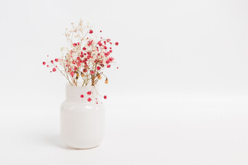 Wall Mural - White pot with flowers on a white background	
