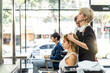 © Kawee - Asian professional female stylist cutting woman's hair in salon. The woman hairdresser using scissors cut the young girl sitting in the shop looking at mirror with smile. Beauty salon business concept