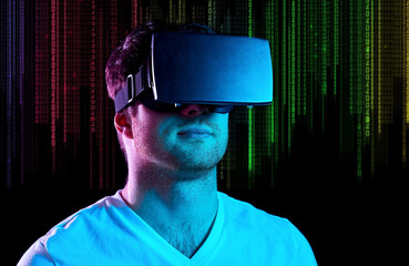Wall Mural - 3d technology, virtual reality and programming concept - young man in vr glasses playing game over ultra violet, neon lights and binary code on black background