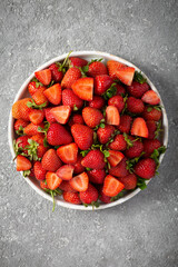 Wall Mural - Ripe delicious strawberries on a white plate, top view