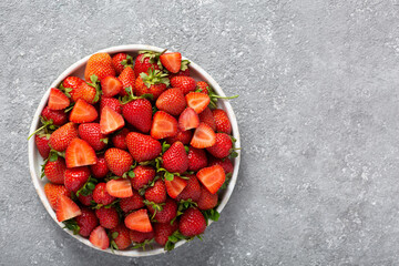 Wall Mural - Ripe delicious strawberries on a white plate, top view