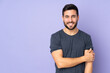 © luismolinero - Caucasian handsome man laughing over isolated purple background