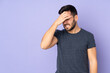 Caucasian handsome man with headache over isolated purple background
