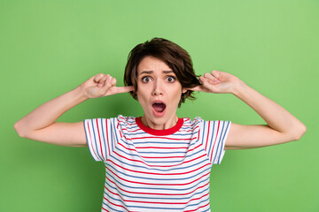 Wall Mural - Portrait of pretty desperate girl closing ears unpleasant noise isolated over green pastel color background