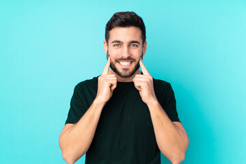 Canvas Print - Caucasian handsome man isolated on blue background smiling with a happy and pleasant expression