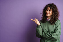 Happy Puzzled Curly Girl Smiling And Gesturing With Hand