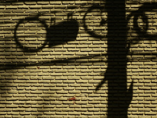 Canvas Print - aged street yellow brick wall with shadow of electric pole