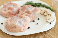 Raw Turkey Chicken Tail On A Plate On A White Background. Isolate. Copy Space.