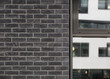 Schwarze brick wall with window. Brick wall facade. 
Black Backsteinmauer mit Fenster. 
Ziegelmauer Fassade