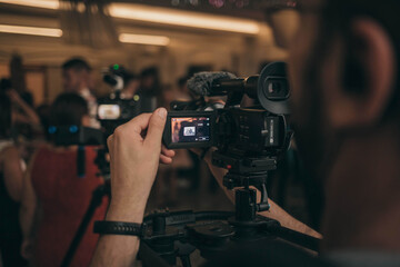 Shallow focus of a cameraman filming a wedding celebration in a restaurant