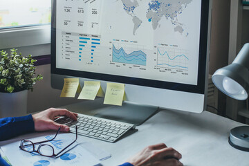 business man analyzing financial report on screen of computer, finance analytics of company performa