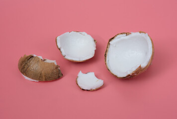 Poster - Parts of fruits coconut on a pink background,Cracked coconut