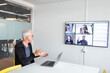 © Johnér - Man in boardroom having video conference