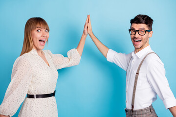 Photo of impressed funny two persons dressed white clothes giving high five open mouth isolated blue color background