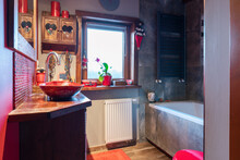 Small Bathroom In Rustic Style With Window, Wooden Decor  And Red Decoration. Vintage Interior With Wood, Bath And Stylish Wash Basin In A Cottage.