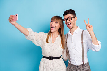 Sticker - Photo of funny sweet two persons dressed white clothes tacking selfie modern device showing v-sign isolated blue color background