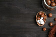 © New Africa - Half of tasty chocolate egg and candies on black wooden table, flat lay. Space for text