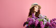 © zamuruev - Portrait of a happy beautiful young girl with basket full of lilac on pink background.