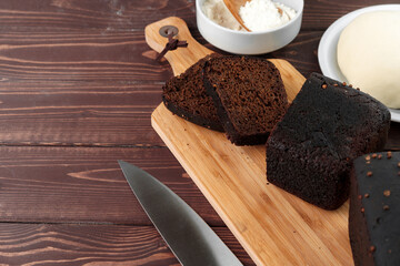 Sliced rye bread on brown wooden background