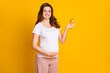 © deagreez - Photo of pretty shiny woman expecting child wear white outfit belly holding fruit isolated yellow color background