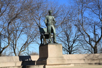 The Lincoln Standing statue in Chicago's Lincoln Park is a lifelike bronze statue of the former president.  The Lincoln Sitting statue is in Chicago's Grant Park about 10 miles to the south.