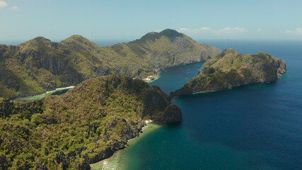 Bay and the tropical islands. Seascape with tropical rocky islands, ocean blue wate, aerial view. islands and mountains covered with tropical forest. El nido, Philippines, Palawan. Tropical Mountain