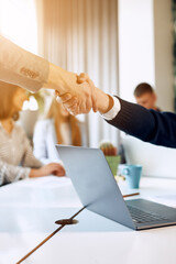 Close up view of business partnership handshake. Photo of two businessman handshaking process. Successful deal after great meeting.