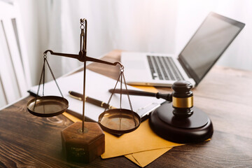 Business and lawyers discussing contract papers with brass scale on desk in office. Law, legal services, advice, justice and law concept picture with film grain effect