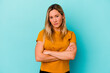 © Asier - Young mixed race woman isolated on blue background frowning face in displeasure, keeps arms folded.