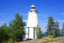 Old Wooden Lighthouse At Cape Besov Nos (Devils Nose) On The East Coast Of Lake Onega, Karelia, Russia North.