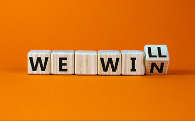 We will win symbol. Turned a wooden cube and changed words we will to we win. Beautiful orange background, copy space. Business, motivational and we will win concept.