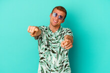 Young Caucasian Man Wearing A Summer Clothes Isolated On Blue Background