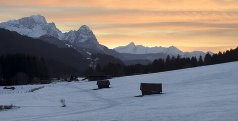 Wall Mural - sunset in the mountains - wooden huts and sahara sand creating epic atmosphere