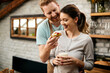 © Drazen - Happy man feeding his girlfriend in the morning in the kitchen.
