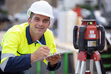 mature man geometer measuring construction place