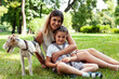 © iordani - young pretty caucasian mother walking with little cute daughter and dog fox terrier, lifestyle people concept
