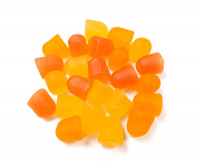 Wall Mural - Close-up texture of orange and yellow multivitamin gummies on white background.  Healthy lifestyle concept.