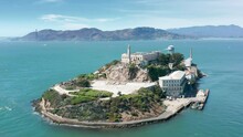 Panoramic Close Up View On Alcatraz Island 4K Aerial. Historic Building In Blue Pacific Ocean Waters. World Famous Landmark Alcatraz Island National Park. Prison Building On Rock In San Francisco Bay