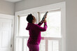 © Gerald Carter/Creative Flame - Black woman caulks window sill, energy efficiency, home improvement, DIY