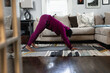 © Gerald Carter/Creative Flame - Black woman does downward dog yoga pose at home