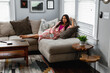 © Gerald Carter/Creative Flame - Indian woman cozy on couch at home