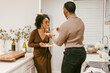 © Melissa Alexander/Creative Flame - Young couple eats takeout at home in kitchen, date night at home
