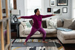 © Gerald Carter/Creative Flame - Black woman does warrior yoga pose, at home fitness and wellness