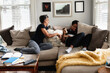 © Gerald Carter/Creative Flame - Black mother and son laughing together on couch, loving moment